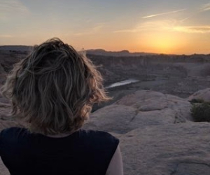 picture of a woman looking at the sunset