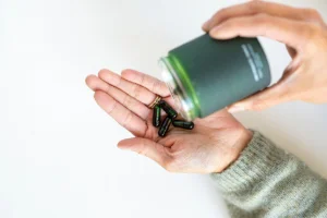 A hand with supplements for nutritional needs