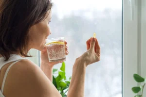A taking a vitamin supplement